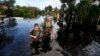 Kelly McClenthen returns to see the flood damage to her home with her boyfriend Daniel Harrison in the aftermath of Hurricane Irma in Bonita Springs, Fla., Sept. 11, 2017. 