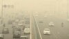 Traffic moves on a road enveloped by toxic smog in New Delhi, India, on Nov. 3, 2023.
