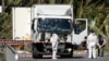 Investigators continue to work at the scene near the heavy truck that ran into a crowd at high speed killing scores who were celebrating the Bastille Day, July 14 national holiday on the Promenade des Anglais in Nice, France, July 15, 2016. 
