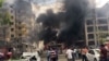 FILE - People watch after a Kurdish rebel suicide bomber detonated an explosives-laden vehicle outside a police headquarters in Midyat, near Turkey's border with Syria, June 8, 2016.