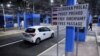FILE - A vehicle passes through a visa-free border crossing in the EU's Schengen zone, in Bregana, Croatia, Jan. 1, 2023. Kosovo is joining the zone on Jan. 1, 2024. 