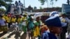 Supporters of the Zimbabwe ruling party The Zimbabwe African National Union Patriotic Front (ZANU-PF) receive food parcels as they arrive at an election campaign rally for aspiring member of Parliament Mabvuku, Tafara constituency, in Harare, on Dec. 7, 2023.