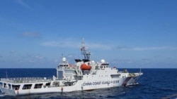 2024年2月8日，菲律賓南中國海斯卡伯勒淺灘附近，一艘中國海岸警衛隊船隻在菲律賓海岸警衛隊船隻特雷莎·馬格巴努亞號附近演習.