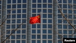 A Chinese flag flutters in Beijing, Feb. 24, 2022. Chinese state media reported on May 18, 2024, that the head of China's Ministry of Agriculture and Rural Affairs is being investigated on charges of corruption.