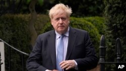 FILE - Former British Prime Minister Boris Johnson leaves his house in London, March 22, 2023.