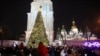 People take photographs as they attend the lighting ceremony for the Christmas tree on Sophia Square in Kyiv, Dec. 6, 2023, amid the Russian invasion of Ukraine.