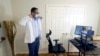 FILE - Medical director of Doctor on Demand Dr. Vibin Roy prepares to conduct an online visit with a patient from his work station at home, April 23, 2021, in Keller, Texas. 