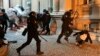 Policajci tuku i privode učesnike protesta protiv izbornih nepravilnosti, tokom skupa ispred Skupštine Grada Beograda, u Beogradu, 24. decembra 2023.