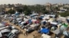Displaced Palestinians, who fled their homes amid an Israeli offensive, shelter in tents in Khan Younis, in the southern Gaza Strip, Nov. 19, 2023.