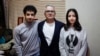 Iranian journalist Taghi Rahmani, center, husband of Iranian rights campaigner and 2023 Nobel Peace Prize laureate Narges Mohammadi, poses with his 17-year-old children, Ali, left, and Kiana during an interview in his apartment in Paris on Dec. 5, 2023. 
