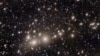 Galaxies belonging to the Perseus Cluster and others farther away are captured by the Euclid telescope, which was designed to explore the dark matter and dark energy that are thought to make up 95% of the universe. (European Space Agency via Reuters)