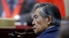 FILE - Peru's former President Alberto Fujimori listens to a question during his testimony in a courtroom at a military base in Callao, Peru, March 15, 2018. Fuijimori is serving a 25-year sentence for human rights abuses and corruption during his rule through the 1990s.