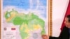 Chairman of the Special Commission for the Defense of Guyana Essequibo Hermann Escarra stands next to Venezuela's new map that includes the Essequibo territory in Caracas, Venezuela, Dec. 8, 2023.