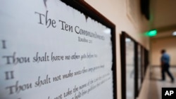 FILE - A copy of the Ten Commandments is posted along with other historical documents in a hallway of the Georgia Capitol, in Atlanta, June 20, 2024.