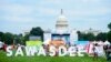 People walk past a sign 'Sawasdee' or Hello in Thai during the Sawasdee DC Thai Festival 2023.