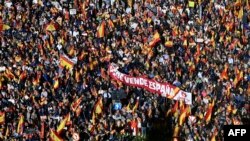 Tens of thousands of people rally around a banner that says "PSOE sells Spain" during a protest against an amnesty bill for those involved with Catalonia's failed 2017 independence bid, in Madrid, Nov. 18, 2023. 