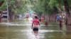 In this image from video, residents move through floodwaters in the town of Beledweyne, Somalia, Nov. 19, 2023. 