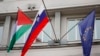 A Palestinian flag flies next to a Slovenian, center, and a European Union flag, right, at the government building in Ljubljana, Slovenia, May 30, 2024.