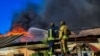 FILE -Firefighters pushing out a fire in a warehouse after shelling in Kherson, Sept. 19, 2023. (AFP photo / Handout / Ukrainian Emergency Service)