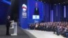 Russian President Vladimir Putin, left, delivers a speech at the United Russia party congress in Moscow, Dec. 17, 2023. (Mikhail Klimentyev, Sputnik, Kremlin Pool Photo via AP)