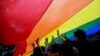 FILE - Participants hold a giant rainbow flag during an LGBTQ+ Pride Parade in Hong Kong on Nov. 8, 2014. Same-sex couples won an appeal on Oct. 24, 2023, on a ruling that grants them equal inheritance rights.
