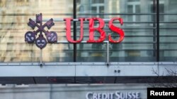 Logos of Swiss banks UBS and Credit Suisse are seen in Zurich, Switzerland March 20, 2023. REUTERS/Denis Balibouse