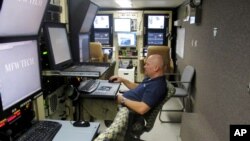 FILE - Dave Kosmowski works on preflight aircraft sensor duties at Grand Forks Air Force Base, North Dakota, Nov. 3, 2015. A proposed rule change requires foreign buyers to get approval from the U.S. government to buy property within 160 kilometers of eight military bases.