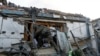A military investigator gets out of the window of a house hit by shelling, that killed a man and injured a woman, in Donetsk, Russian-controlled Ukraine, Oct. 24, 2023.