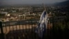 An Israeli flag hangs on an area backdropped by buildings in Kiryat Shmona, a city next to the border with Lebanon, northern Israel, June 19, 2024. 