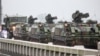 Taiwanese armored vehicles roll down a street in Kinmen on May 24, 2024. China warned on May 24 that Taiwan's leadership was pushing the self-ruled island into "a perilous situation of war and danger."