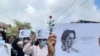 Demonstrators hold papers printed with Aung San Suu Kyi’s famous quote as they rally to mark her 79th birthday in Launglon township in Tanintharyi region, Myanmar, June 19, 2024.
