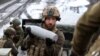 A Ukrainian artilleryman of the Aidar battalion holds an artillery shell on a front line position near Bakhmut, Donetsk region, on April 22, 2023.