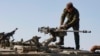 An Israeli soldier checks a weapon in the Israel-annexed Golan Heights near the border with Syria, Dec. 28, 2023. The Israeli army said Saturday that it was carrying out strikes in Syria after two rockets fired from Syria fell into territory under Israel's control.  