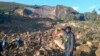 People gather at the site of a landslide in Maip Mulitaka in Papua New Guinea's Enga Province on May 24, 2024. Local officials and aid groups said a massive landslide struck a village in Papua New Guinea's highlands on May 24, with many feared dead. 