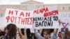 Protesters hold banners during a demonstration in front of the parliament building, following the fatal collision of two trains, in Athens, March 12, 2023. The banners read 'They were students. The train car sank with students' blood.'