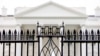 FILE - The White House is visible through the fence at the North Lawn in Washington, on June 16, 2016. A driver died Saturday night, May 4, 2024 after crashing a vehicle into a gate at the White House, authorities said. 
