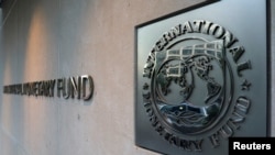 FILE - The International Monetary Fund logo is posted at IMF headquarters in Washington, Sept. 4, 2018. 