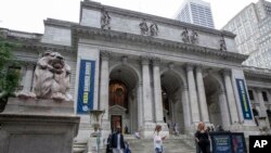 FILE - A "Read Banned Books" banner hangs at the New York Public Library in Manhattan during Banned Books Week in New York City, September 22, 2022.