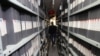 An employee walks between shelves at the archives department of the Tele Liban network in Beirut, Lebanon, Dec. 29, 2023.