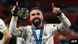 Real Madrid's defender #02 Dani Carvajal celebrates the victory at the end of the UEFA Champions League final football match between Borussia Dortmund and Real Madrid, at Wembley stadium, in London, June 1, 2024.