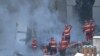 Firefighters work on the rubble at 'rue Tivoli' after a building collapsed in the street, in Marseille, southern France, Apr. 9, 2023.