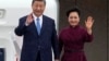 China's President Xi Jinping and his wife Peng Liyuan wave upon their arrival for an official two-day state visit at Orly airport, south of Paris on May 5, 2024. 