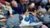 Mourners attend the funeral of Al Jazeera cameraman Samer Abu Daqqa, who according to the Arabic broadcaster, was killed by an Israeli drone strike Friday while reporting on the bombing of a school sheltering people in Khan Younis in the Gaza Strip, Dec. 16, 2023.