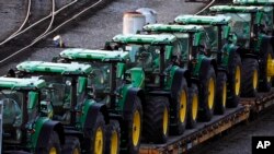 FILE - A line of John Deere tractors sit in Norfolk Southern's Conway Yard in Conway, Pennsylvania, Dec. 5, 2022. U.S. manufacturing activity edged lower in June 2024.