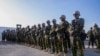 Polisi wa Kenya wakisimama kwenye kambi yao mjini Port-au-Prince wakati wa ziara ya waziri mkuu wa Haiti Garry Conille, Juni 26, 2024. Picha ya AP