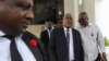 FILE - Garry Conille, second-right, leaves his swearing-in ceremony as prime minister in Port-au-Prince, Haiti, June 3, 2024. 