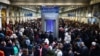 Passengers wait for news of Eurostar departures at St Pancras station in London, Dec. 30, 2023, as services are disrupted due to flooding. 