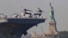 U.S. Sailors and Marines stand on the deck of the USS Bataan as it passes the Statue of Liberty during Fleet Week on in New York, May 22, 2024.