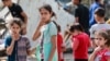 Palestinian children react next to the rubble of the Zaqout family's house hit during overnight Israeli bombardment in Nuseirat, in the central Gaza Strip, on May 30, 2024.