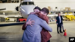 In this photo provided by the Swedish government, Johan Floderus reunites with his family at Arlanda airport in Stockholm on June 15, 2024, after being released from prison in Iran. 